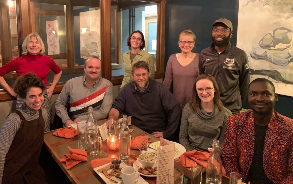 Center for Ethics and Human Values Director Piers Turner and the first eight fellows of the newly established Ethics Circle smile for the camera after a group dinner