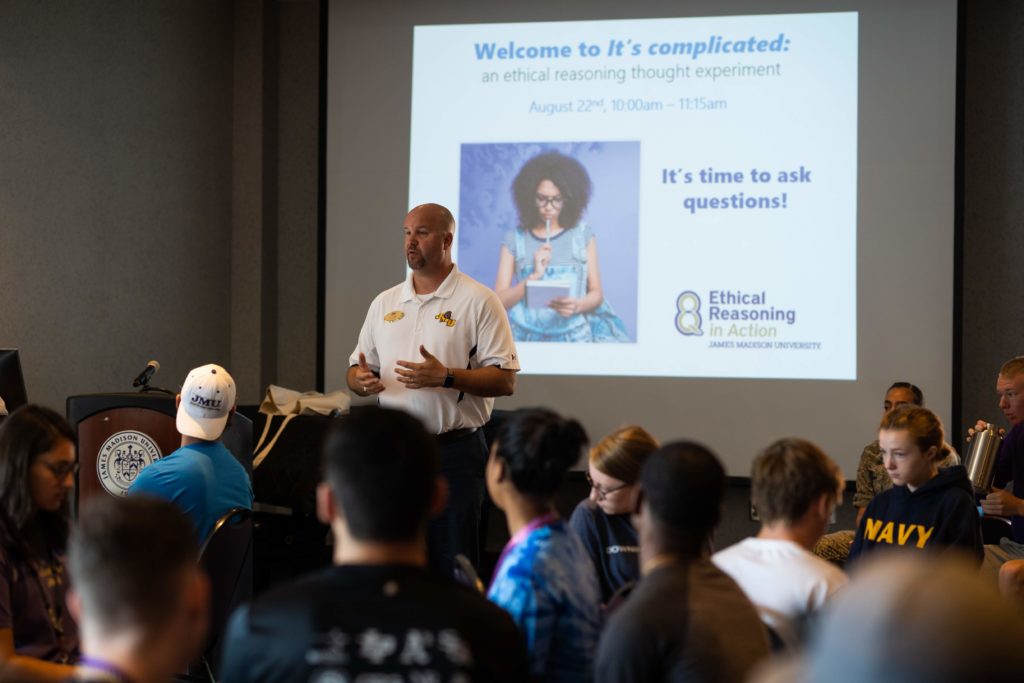 JMU’s Vice President for Student Affairs Tim Miller delivers a presentation on the 8 Key Questions (8KQ) to a room of first year students